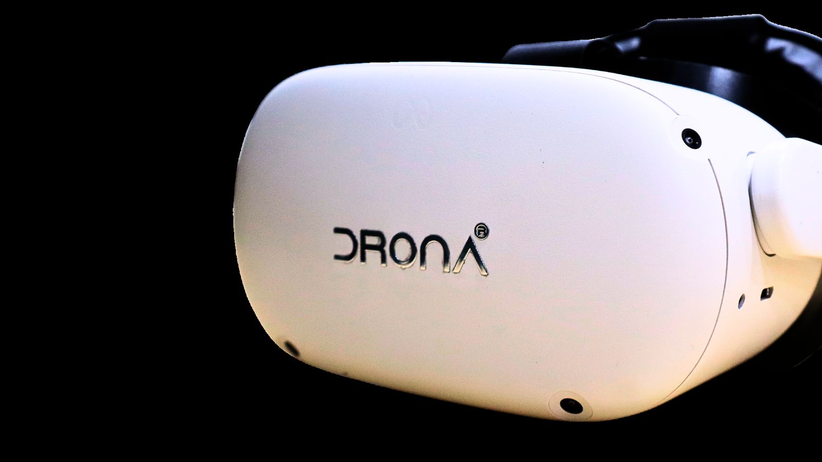 The white Drona VR headset in side profile on a black background