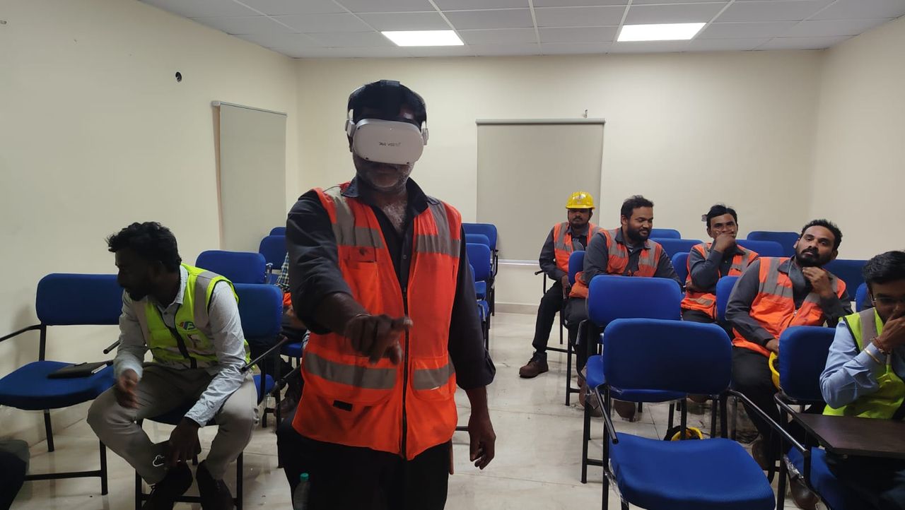 Plant workers in high-visibility vests in a training room during a VB safety training session