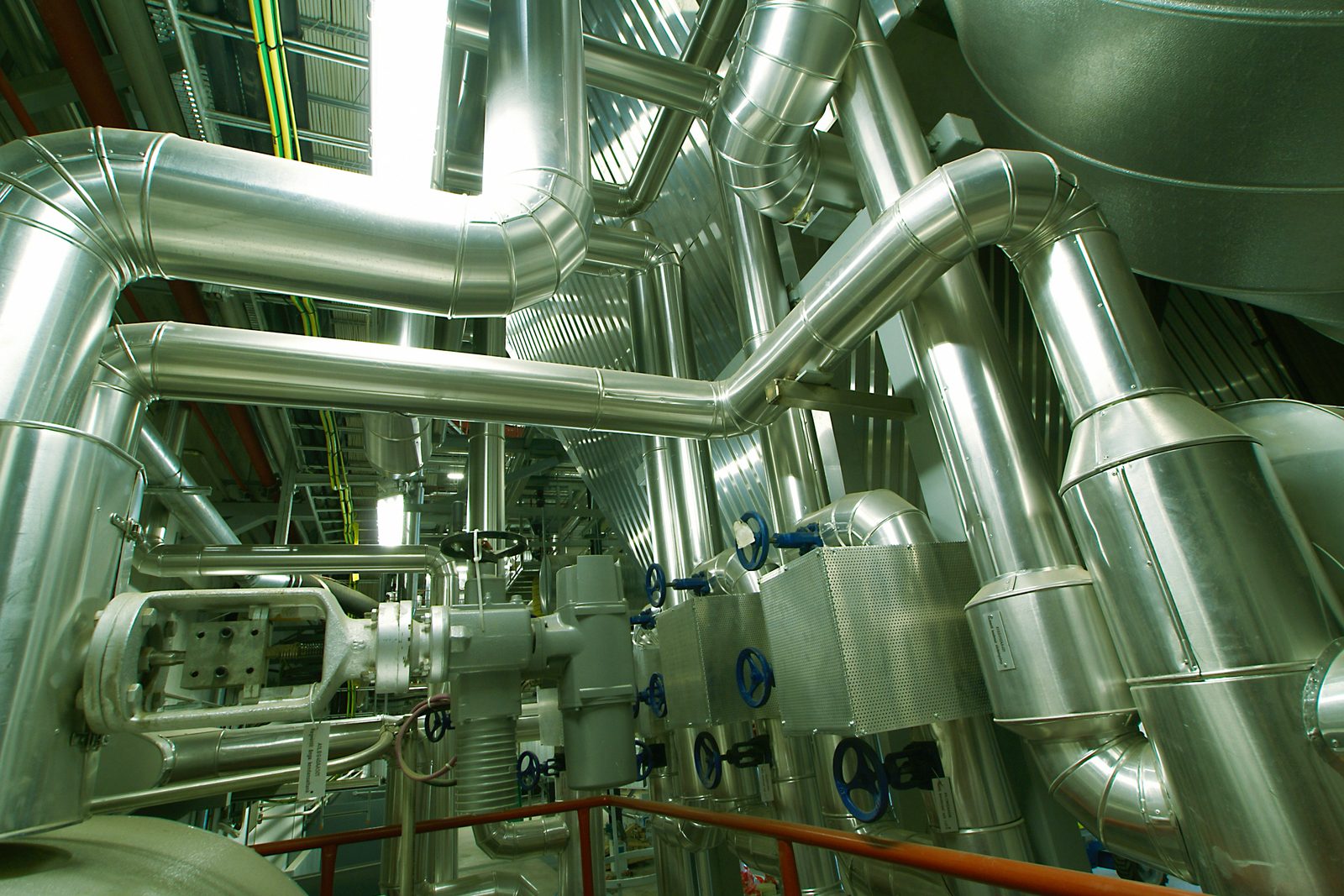 Dense insulated process pipework, headers and valve stations in an operating plant