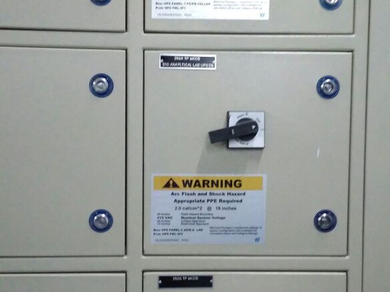 Motor control centre cubicle bank with a VB Engineering arc flash warning label installed on every door